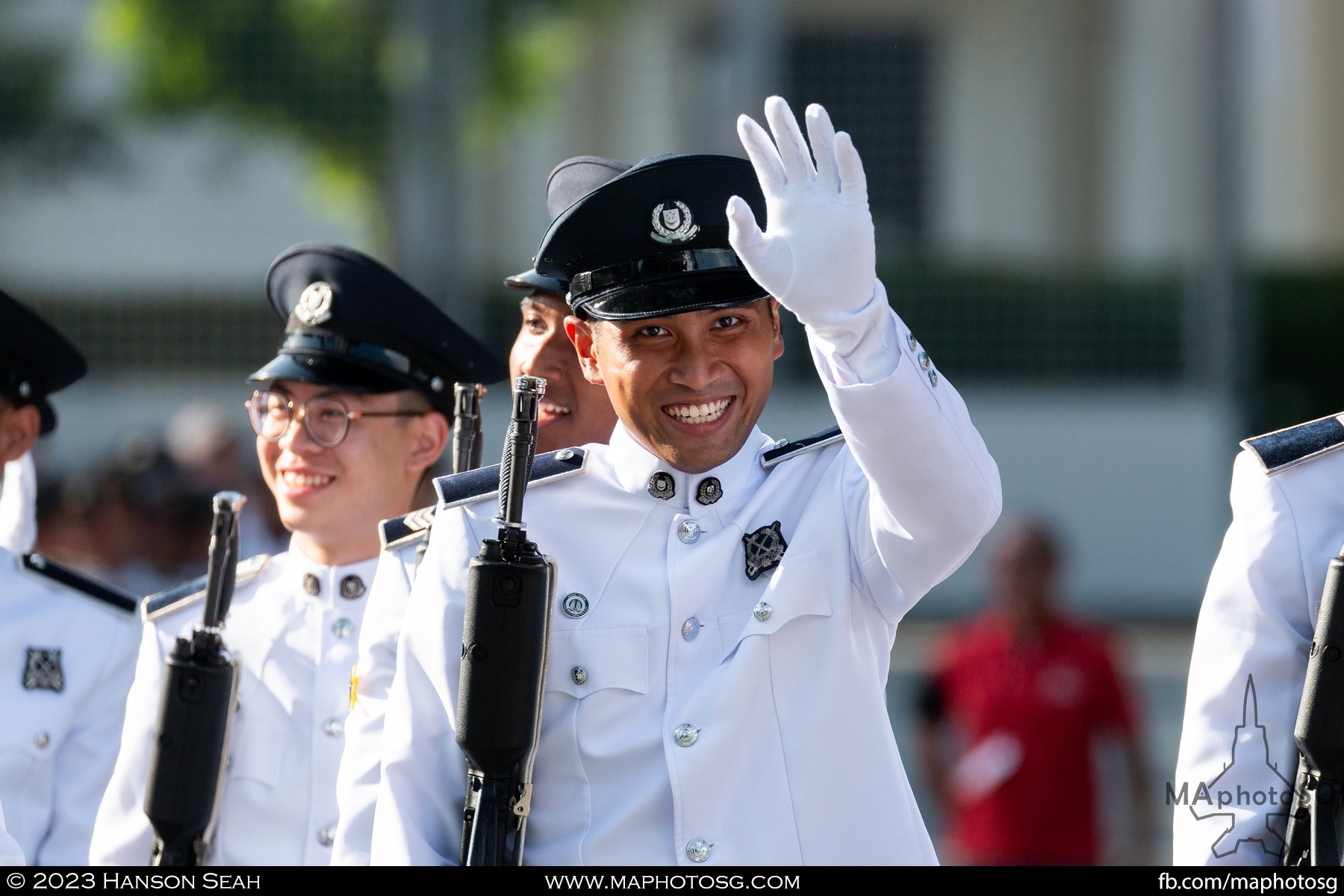 A member of the Singapore Police Force Guard-of-Honour contingent waves to the camera.