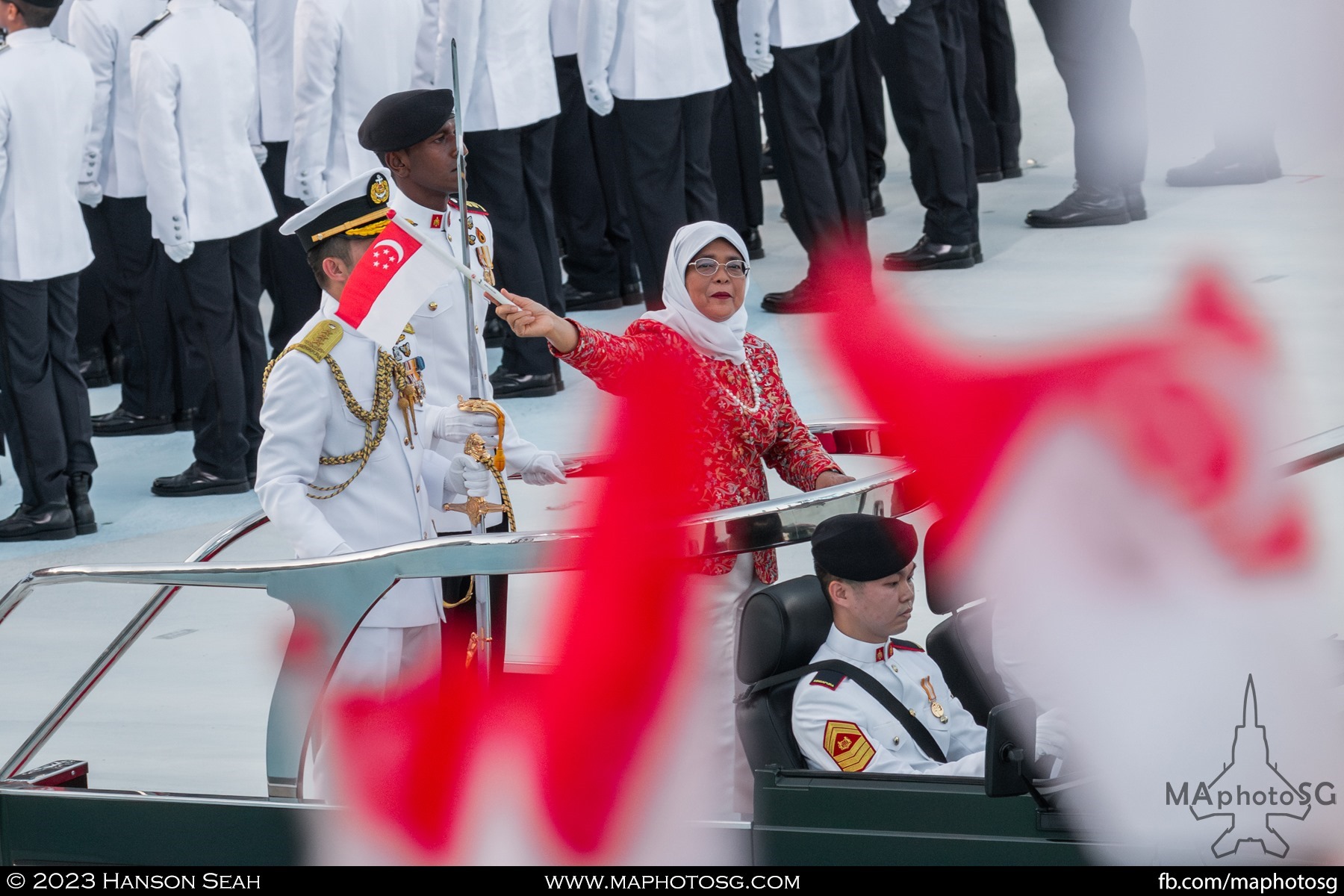President of SIngapore, Mdm Halimah Yacob, waves to the crowd as she embarks on the ceremonial drive past.