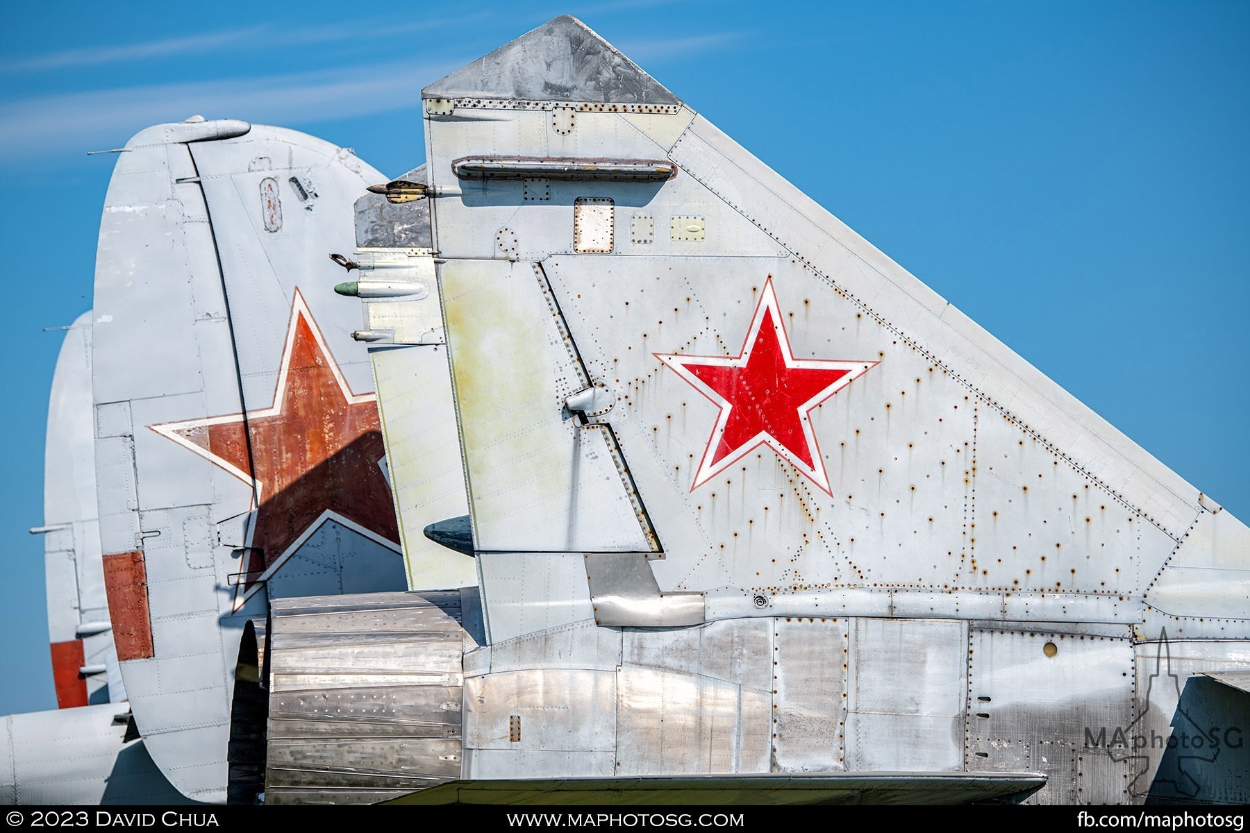 Tail of a Mikoyan MiG-31 and the tail of a Beriev Be-12 behind.