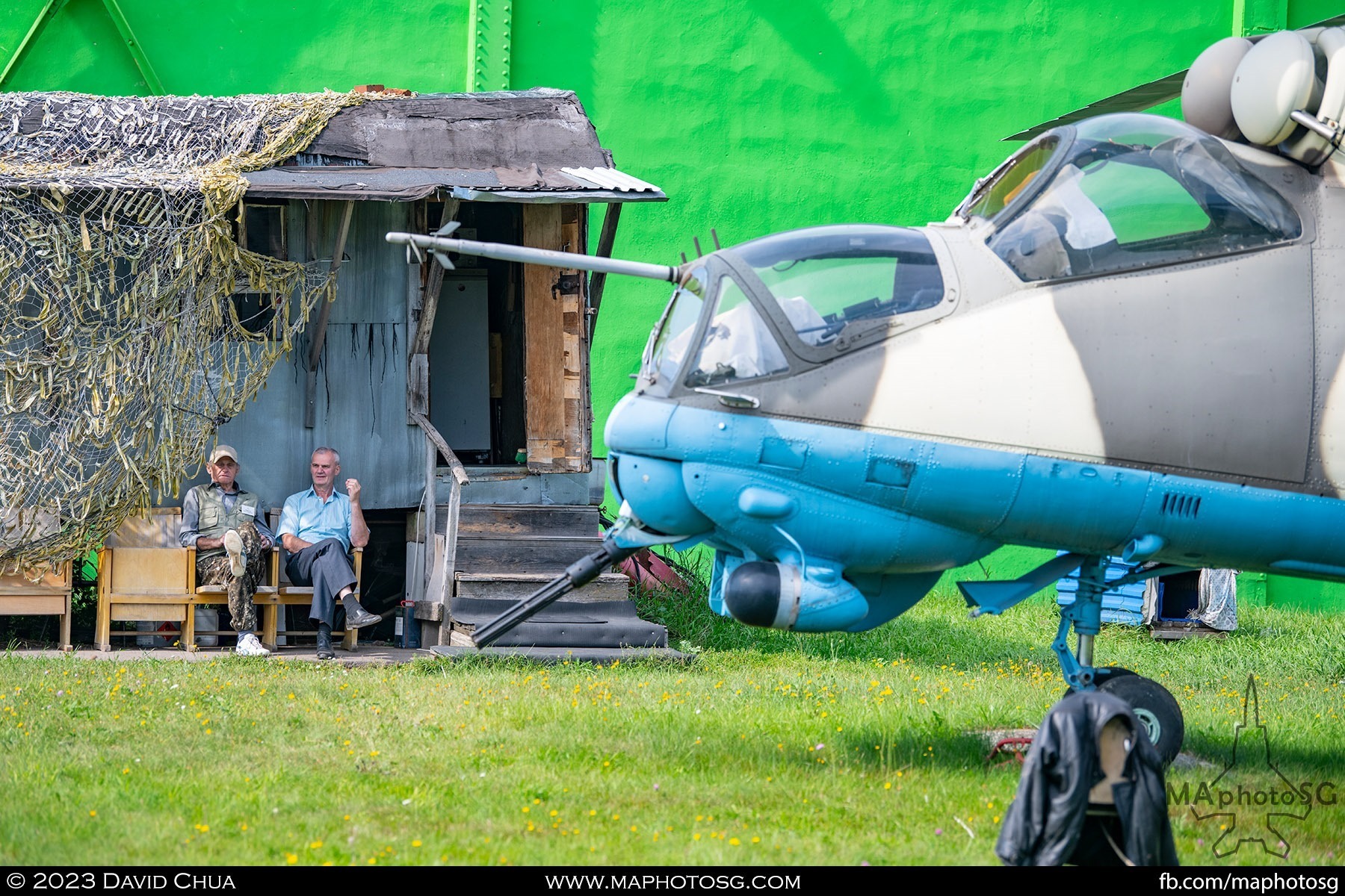 Museum staff rests behind a Mil Mi-24